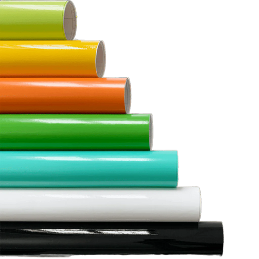 A vibrant stack of ChroMorpher Gloss Vinyl Rolls arranged in layers of lime, yellow, orange, green, teal, white, and black, showcasing their high-gloss finish and versatile application.