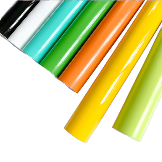 A lineup of ChroMorpher Vibrant Gloss Vinyl Rolls in bold colors such as black, white, teal, green, orange, yellow, and lime, highlighting their glossy surface and premium quality.