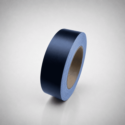 A roll of dark black matte tape standing upright on a light gray gradient background.