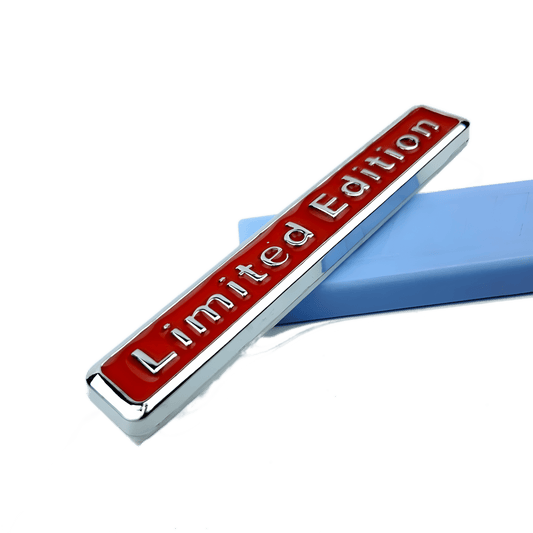 ChroMorpher Limited Edition 3D Metal Emblem displayed on a blue surface, showcasing its shiny red lettering and silver frame, ready for installation.