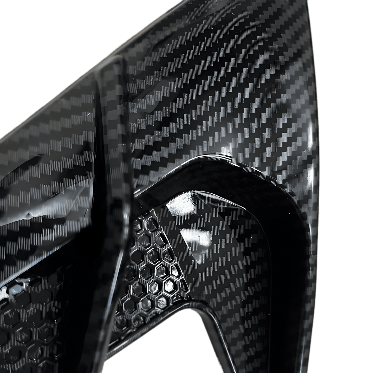 A close-up shot of the ChroMorpher Side Fender Vent in a Carbon Look finish, highlighting the detailed carbon fiber pattern and honeycomb texture. The high-gloss surface reflects light, emphasizing the premium quality and aggressive styling. Designed for universal fit, this fender vent enhances a vehicle’s aerodynamics while adding a sporty, modern touch. Made from durable, weatherproof rubber, it ensures long-lasting performance and easy installation with a self-adhesive backing.