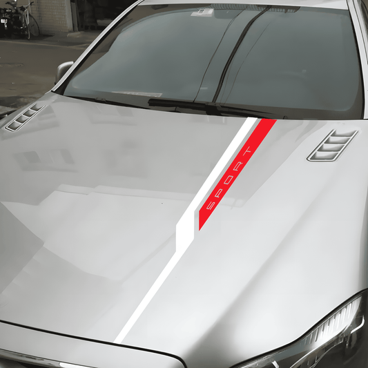 A sleek "SPORT" decal stripe in red and white across the hood of a silver car, giving it a stylish and sporty look.
