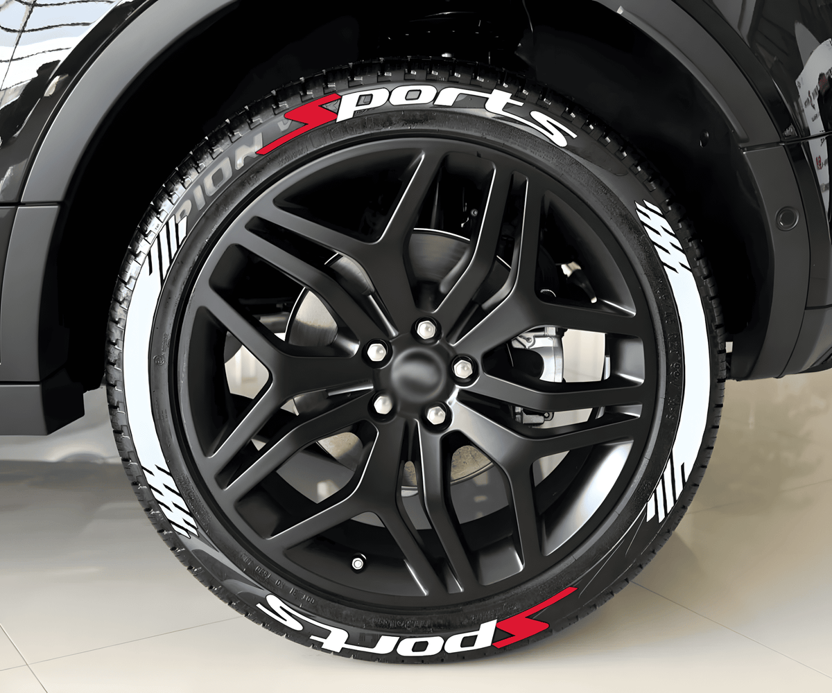 Close-up of a black SUV with ChroMorpher SportsX Tire Lettering applied to the tires. The decals feature bold white "Sports" text with red and white racing stripes, enhancing the vehicle's sporty and high-performance look.