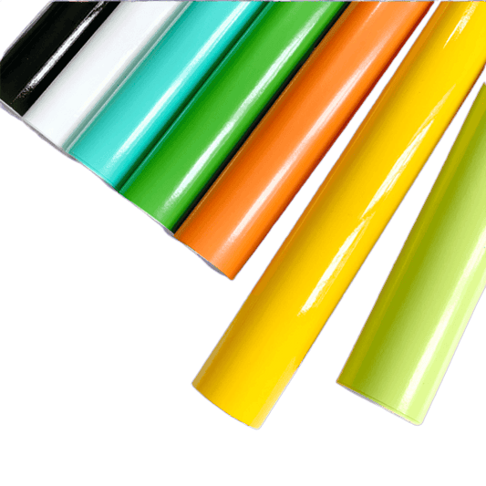 A lineup of ChroMorpher Vibrant Gloss Vinyl Rolls in bold colors such as black, white, teal, green, orange, yellow, and lime, highlighting their glossy surface and premium quality.