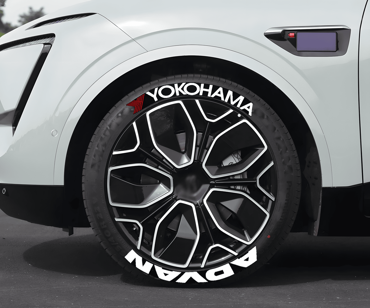 Close-up of a modern white vehicle featuring Yokohama ADVAN 3D tire lettering decals on stylish black and silver wheels. The bold white ADVAN and Yokohama branding with a red accent adds a high-performance and racing-inspired look, ideal for car enthusiasts and JDM lovers.