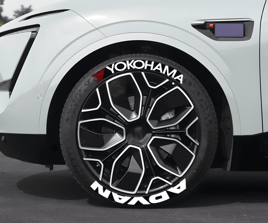 Close-up of a modern white vehicle featuring Yokohama ADVAN 3D tire lettering decals on stylish black and silver wheels. The bold white ADVAN and Yokohama branding with a red accent adds a high-performance and racing-inspired look, ideal for car enthusiasts and JDM lovers.
