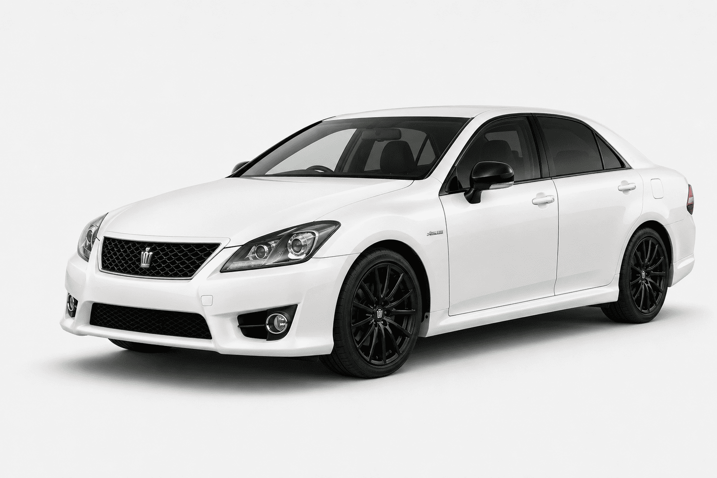 A white Toyota sedan with black multi-spoke wheels, shown from a three-quarter front angle on a light gray studio background.