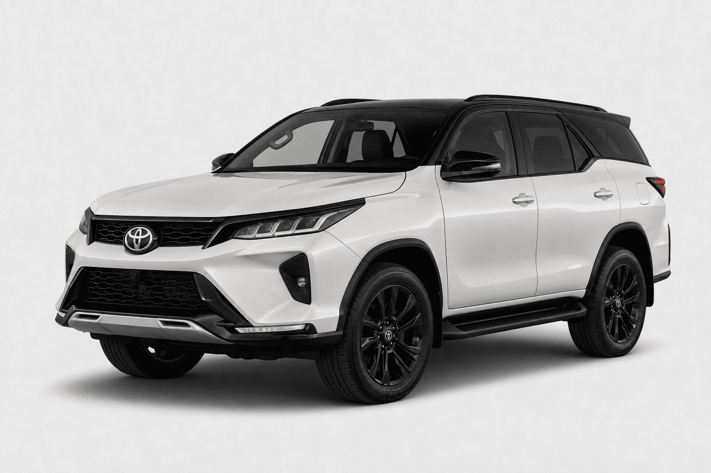 A white Toyota Fortuner SUV with black accents, including the roof, wheels, and trim, shown from a three-quarter front angle on a light gray background.