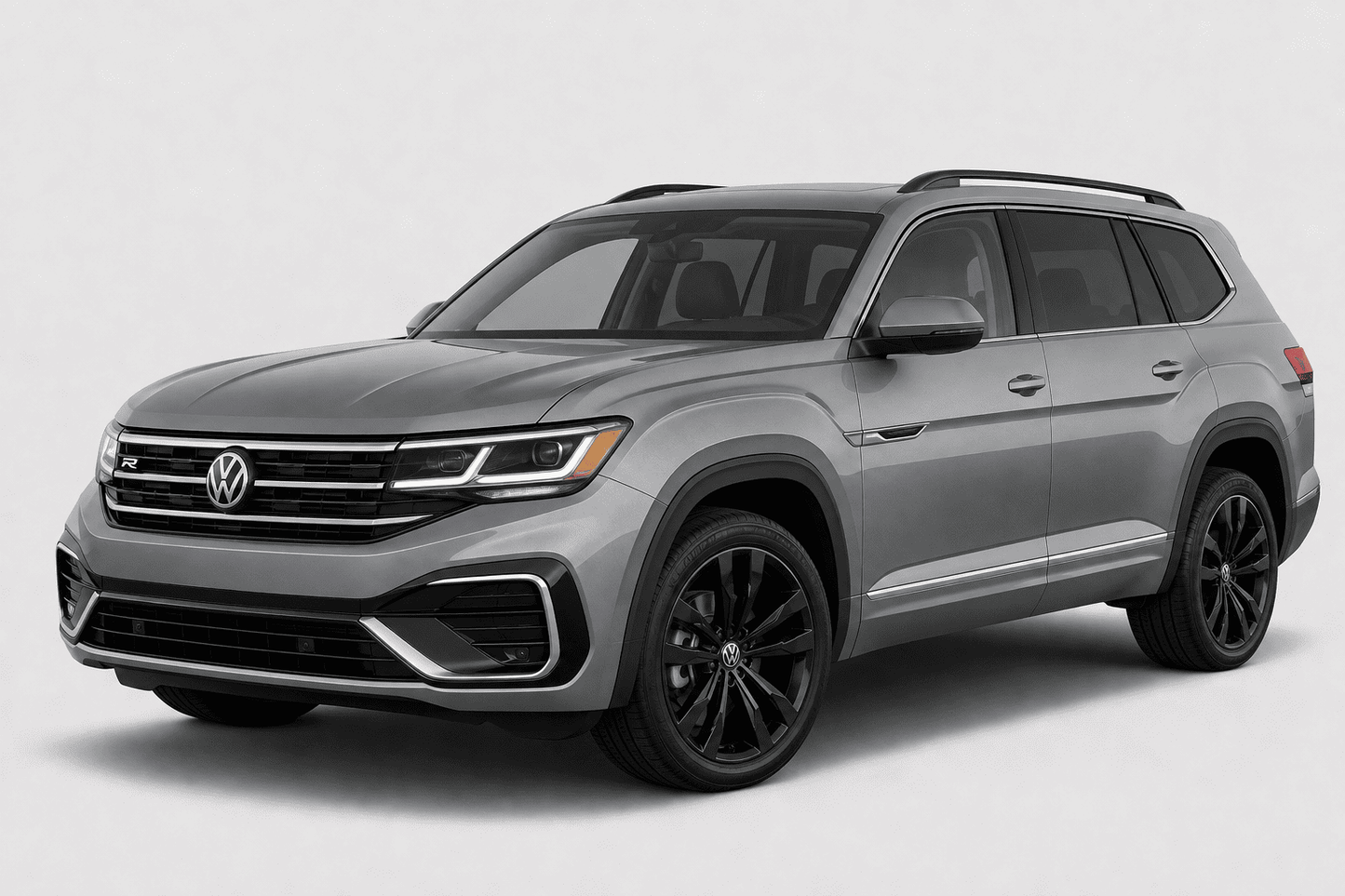 A silver Volkswagen Atlas SUV with black wheels and roof rails, photographed from a three-quarter front angle against a light gray studio background.