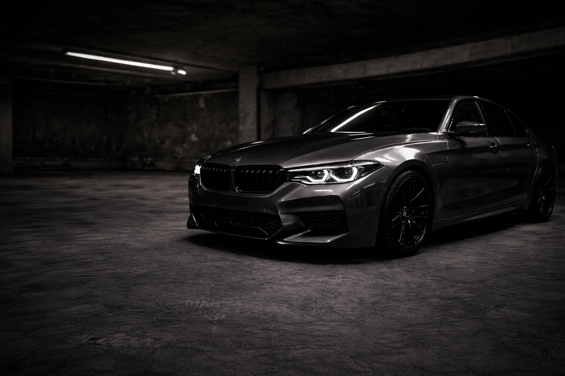 Chrome deleted bmw standing in garage setting.