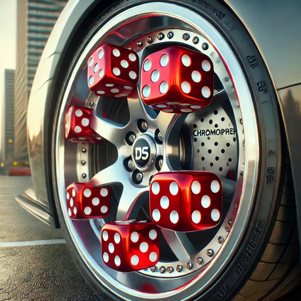 ChroMorpher Lucky Dice Valve Caps installed on a polished sports car wheel, red dice caps with white dots adding a playful retro style, in an urban parking lot setting.