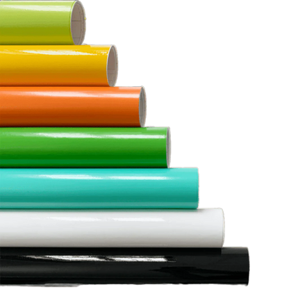 A vibrant stack of ChroMorpher Gloss Vinyl Rolls arranged in layers of lime, yellow, orange, green, teal, white, and black, showcasing their high-gloss finish and versatile application.