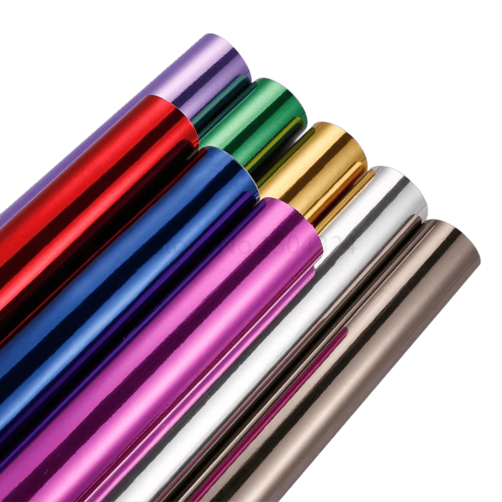 A collection of vibrant Chromorpher Chrome Mirror Vinyl rolls in various colors, including red, blue, green, gold, purple, silver, and bronze, showcasing their glossy, reflective finish perfect for vehicle and accessory customization.