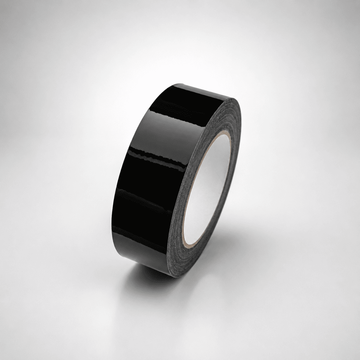 A roll of glossy black tape standing upright on a light gray gradient background.
