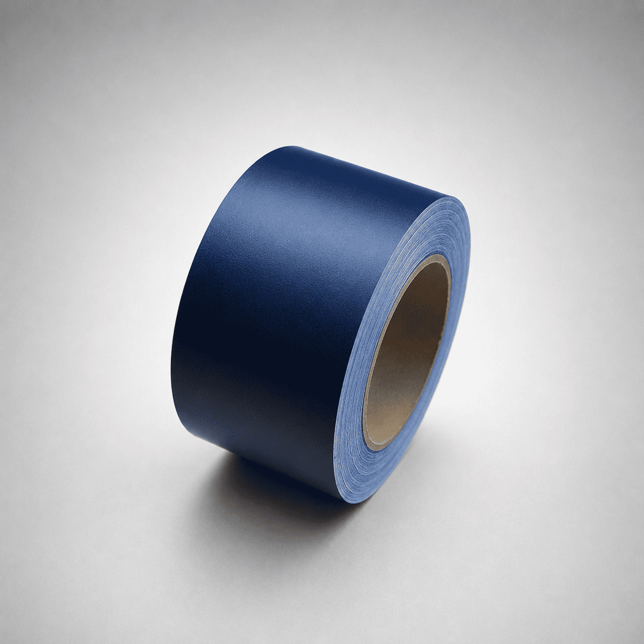 A roll of dark blue tape standing upright on a light gray gradient background.