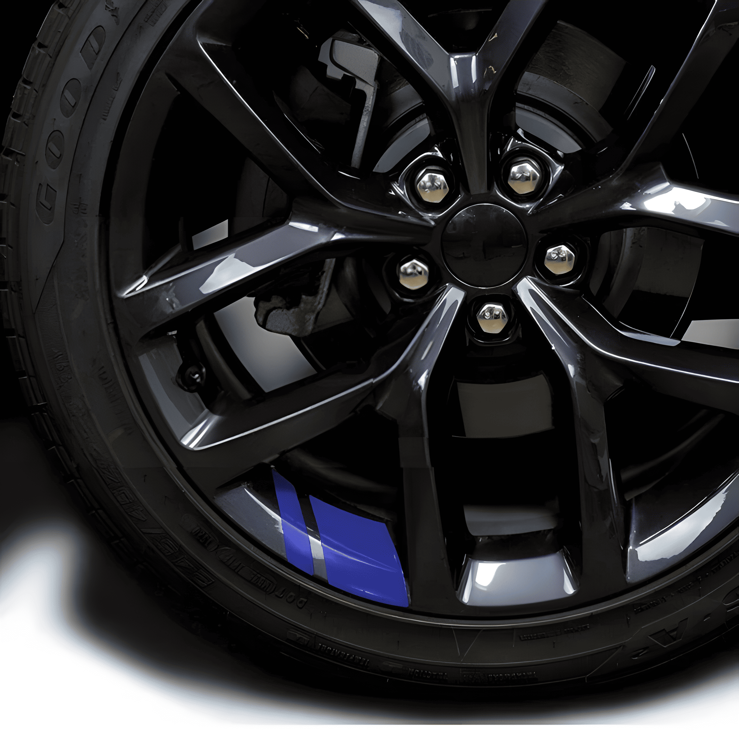 A blue reflective rim decal strip applied to a black alloy wheel, creating a sporty and eye-catching look. These high-quality, waterproof stickers improve visibility and aesthetics, fitting 18'' - 21'' rims for a universal, easy-to-apply customization on cars and motorcycles.