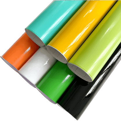A collection of vibrant ChroMorpher Colorful Gloss Vinyl Rolls in various colors including orange, white, green, black, yellow, and mint, showcasing their glossy finish and high-quality material.