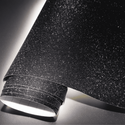 A roll of ChroMorpher black vinyl wrap with a glitter texture, offering a sparkling and luxurious finish

perfect for customizing vehicles, furniture, and other surfaces. Ideal for a bold, eye-catching design.