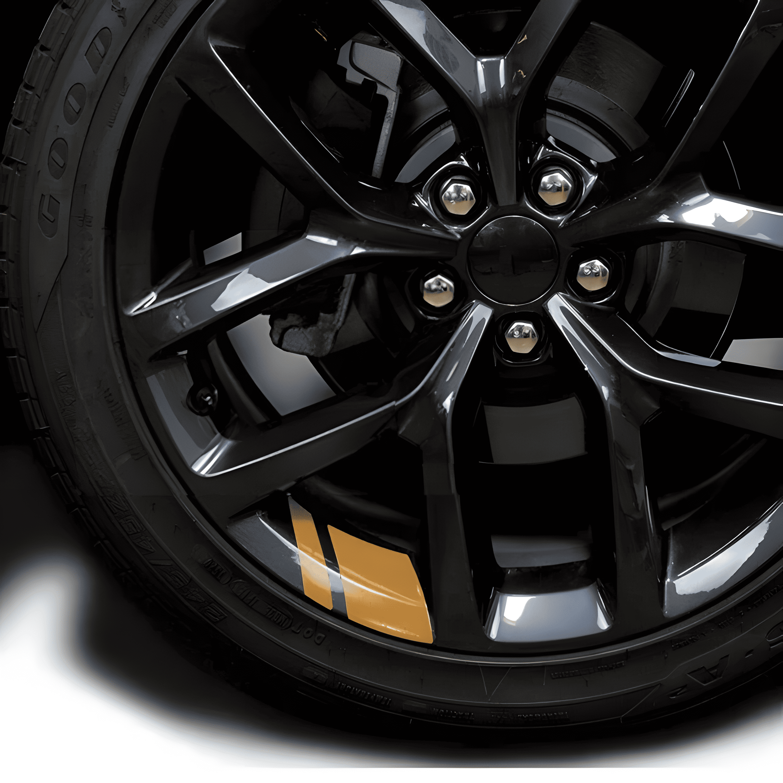 A stylish gold reflective rim decal strip applied to a black alloy wheel, offering a bold contrast and increased visibility at night. These waterproof, precision-cut stickers fit 18'' - 21'' rims, making them a universal choice for enhancing the aesthetic and safety of cars and motorcycles.