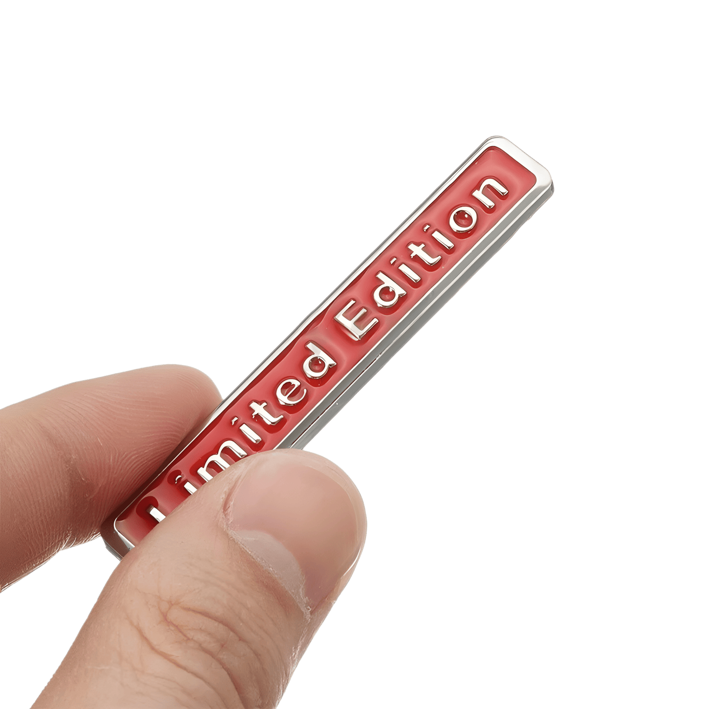 ChroMorpher Limited Edition 3D Metal Emblem held in hand, showcasing its sleek red design on a silver metal background.