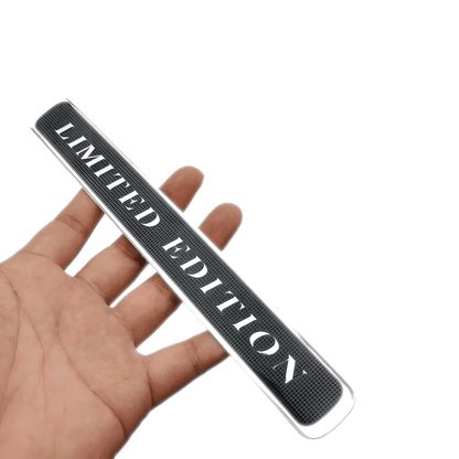 ChroMorpher Limited Edition Emblem held in hand, showing a sleek 3D black and white design for a unique car badge sticker.