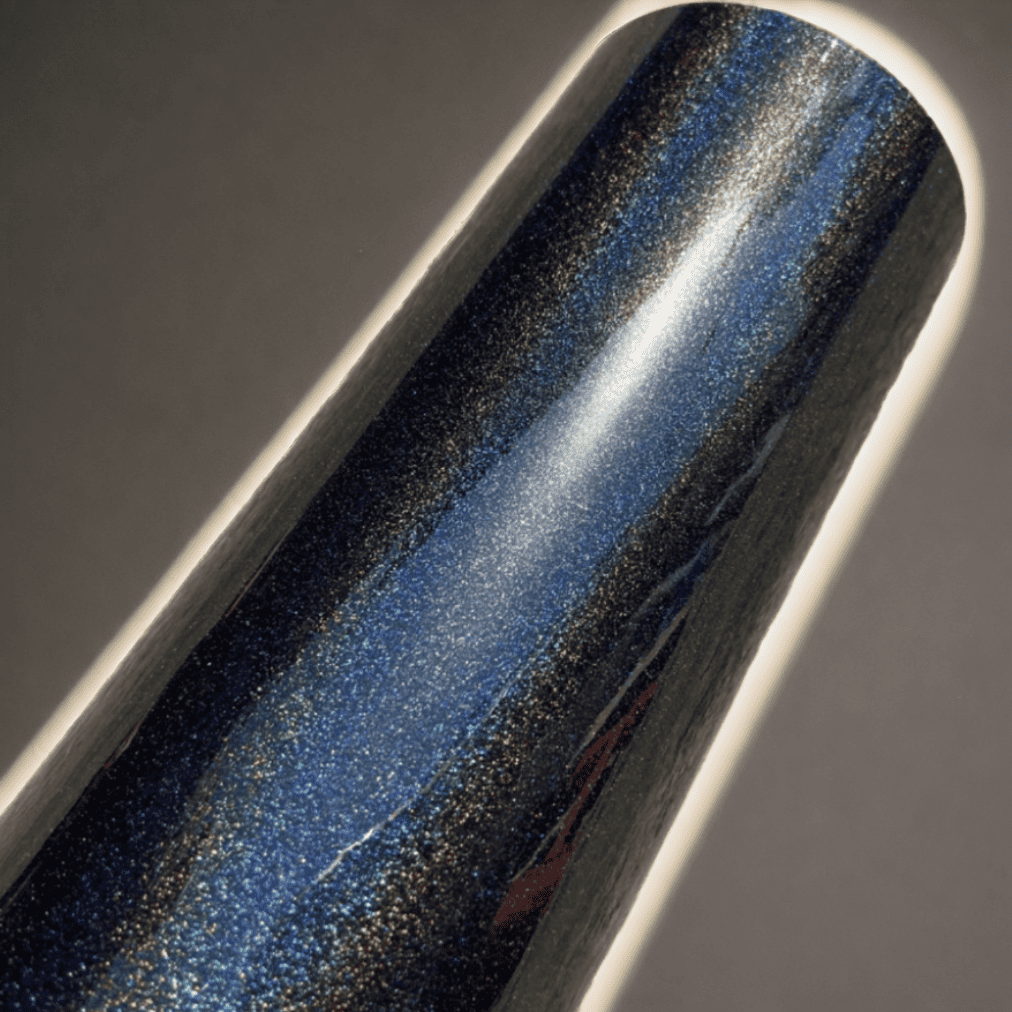 A roll of ChroMorpher midnight blue glitter vinyl wrap, showcasing a shimmering finish with subtle glitter accents, perfect for adding a luxurious and eye-catching touch to vehicles and custom projects.