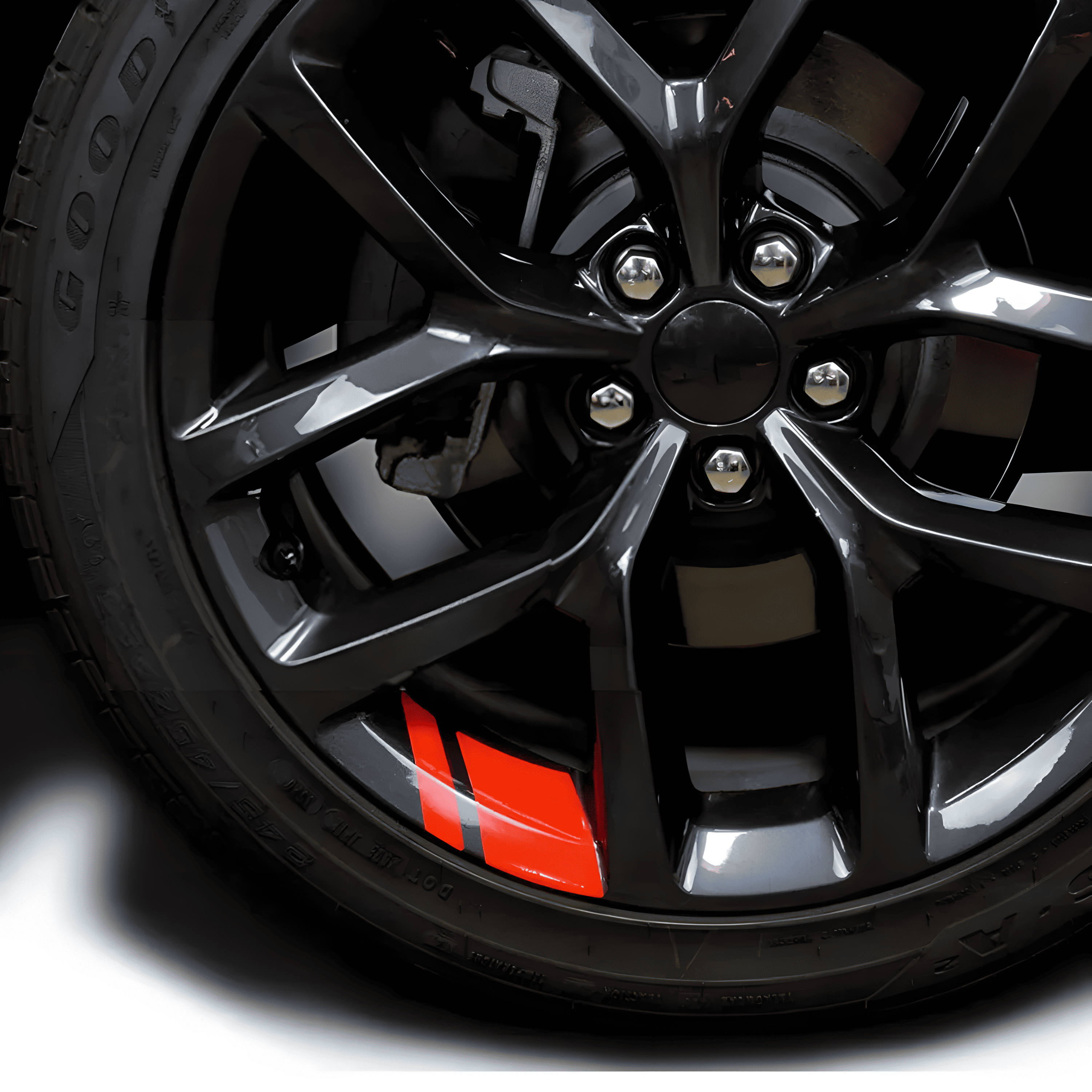 A red reflective rim decal strip applied to a black alloy wheel, enhancing visibility and aesthetics. These durable, waterproof stickers are designed for 18'' - 21'' rims, offering a universal fit for an eye-catching, sporty customization on cars and motorcycles.