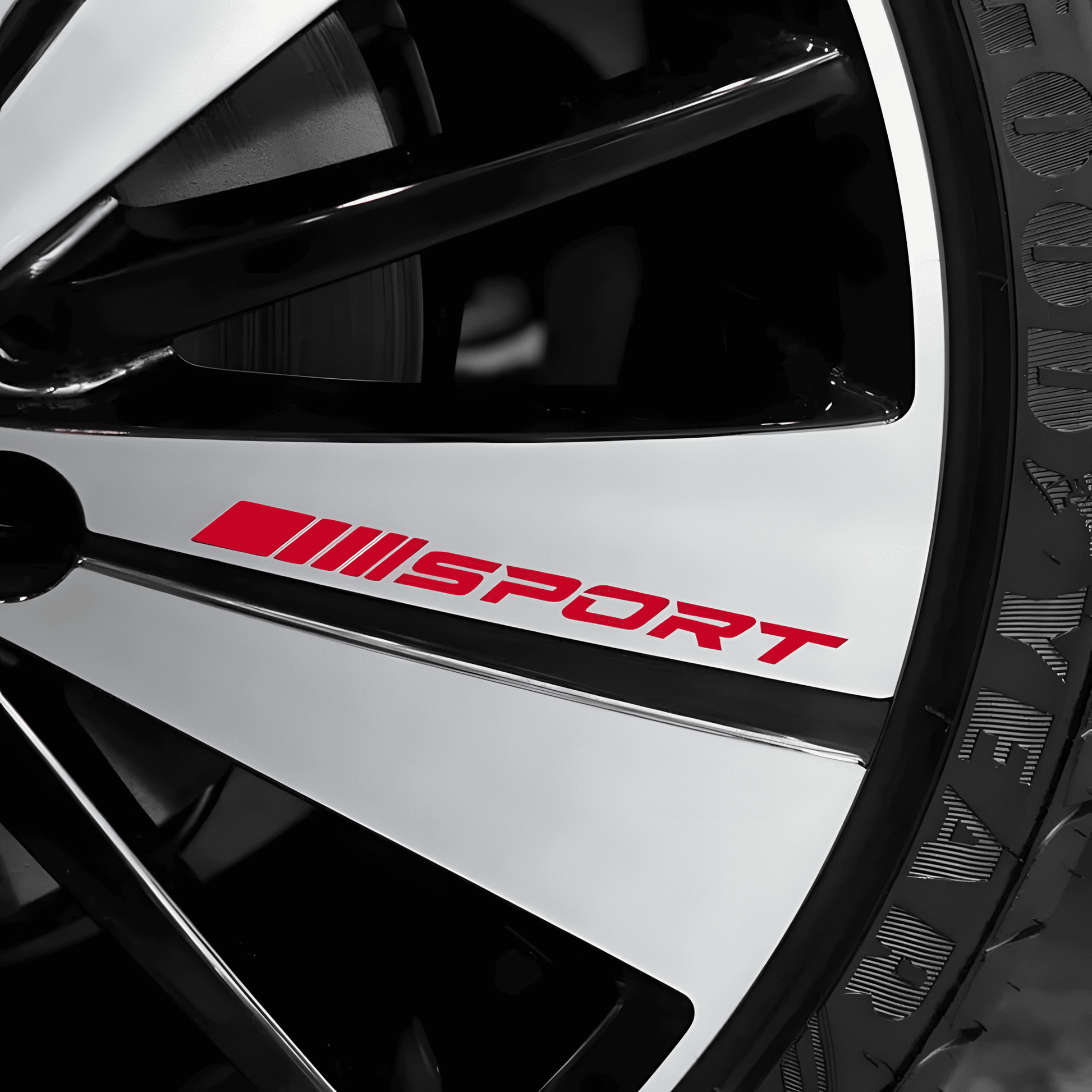 A close-up of a car wheel rim featuring a red "SPORT" racing decal, enhancing the sporty and stylish look of the vehicle. The high-quality vinyl sticker is applied smoothly on the rim, offering a sleek and customized appearance. Ideal for car enthusiasts looking to upgrade their wheel aesthetics.