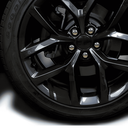 A sleek black reflective rim decal strip applied to a black alloy wheel, blending seamlessly for a stealthy, premium look. Designed to enhance nighttime visibility while maintaining a clean, subtle appearance, these waterproof stickers fit 18'' - 21'' rims for cars and motorcycles.
