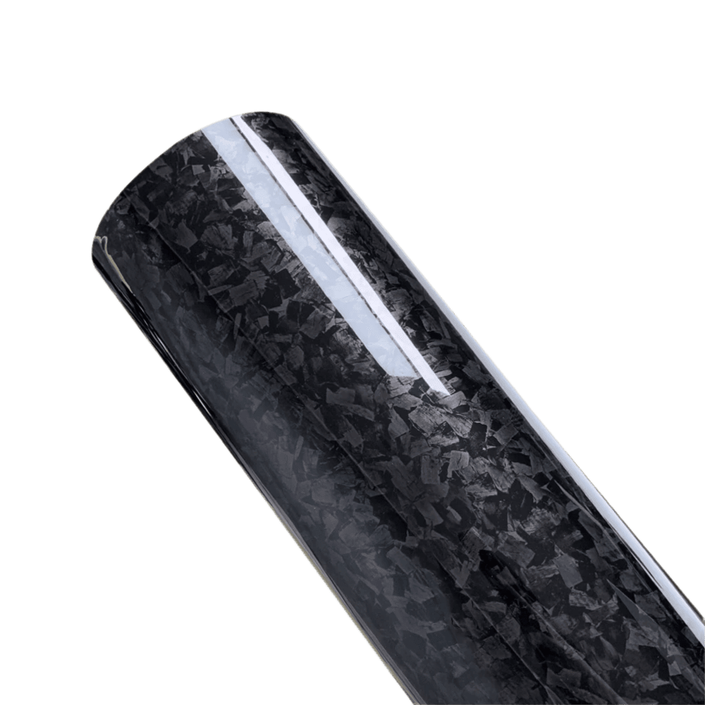 A close-up view of a roll of Glossy Forged Carbon Fiber Vinyl Wrap in a classic black finish. The high-gloss surface highlights its premium forged carbon texture, making it ideal for car and accessory customizations with a modern and professional-grade aesthetic.