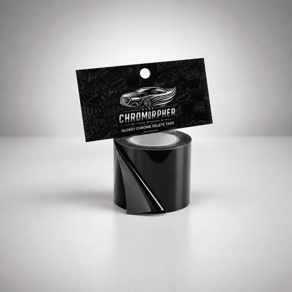 A roll of glossy black chromapher tape with its black hanging card packaging, featuring a silver car graphic and the brand name 'CHROMOPHER', set against a clean gray studio background.