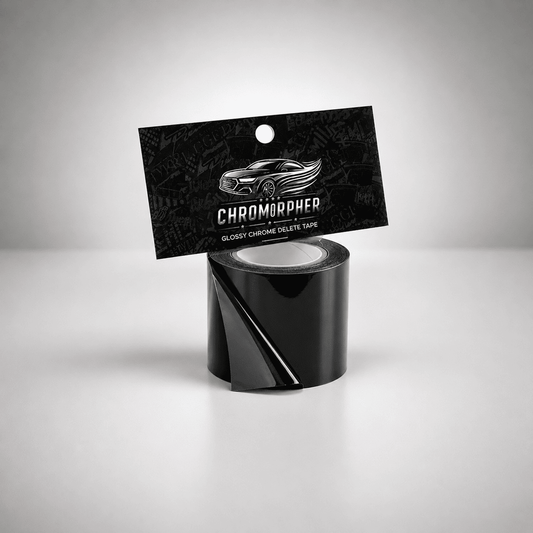 A roll of glossy black chromapher tape with its black hanging card packaging, featuring a silver car graphic and the brand name 'CHROMOPHER', set against a clean gray studio background.