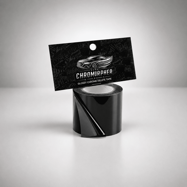 A roll of glossy black chromapher tape with its black hanging card packaging, featuring a silver car graphic and the brand name 'CHROMOPHER', set against a clean gray studio background.