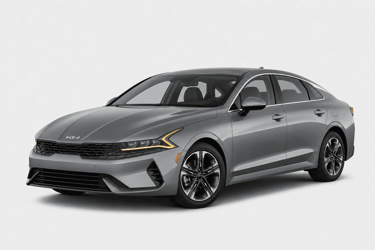 A gray Kia sedan photographed at a three-quarter front angle on a clean light gray studio background.