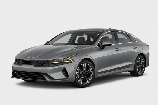 A gray Kia sedan photographed at a three-quarter front angle on a clean light gray studio background.