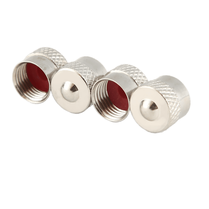 A close-up image of four silver-colored metal tire valve caps with a knurled grip texture and a red rubber seal inside. Two caps are shown with their open threaded ends facing the viewer, while the other two display their smooth, rounded tops.