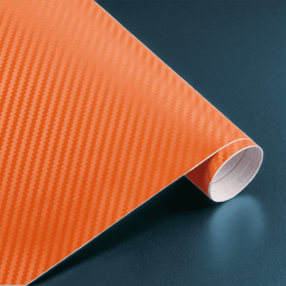 A roll of ChroMorpher carbon fiber vinyl in orange, showcasing a vibrant and realistic 3D carbon fiber texture, ideal for creating a striking and customized finish on vehicles or other surfaces.