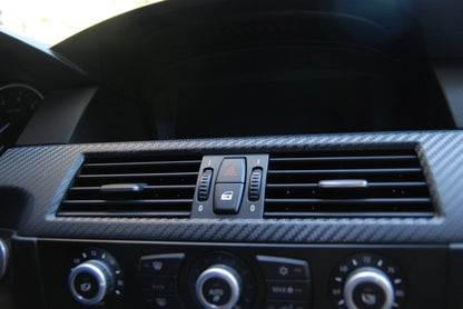 A car dashboard featuring a section wrapped in ChroMorpher matte carbon fiber vinyl, showcasing the sleek and textured finish applied to the surface.