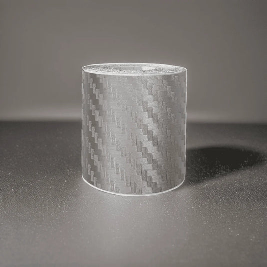 ChroMorpher Carbon Fiber Protective Tape roll displayed on a reflective surface.