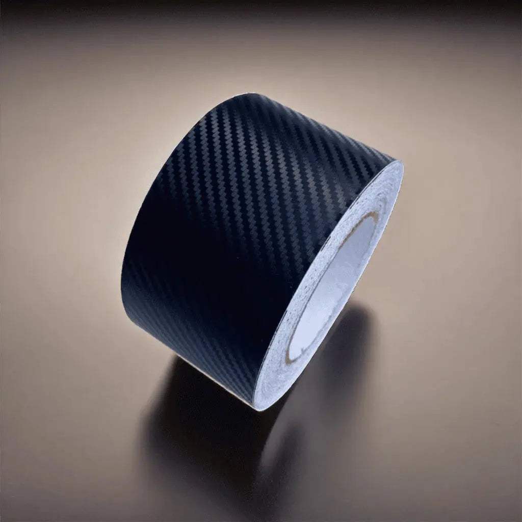 ChroMorpher Carbon Matte Vinyl Tape roll with a subtle carbon fiber texture, ideal for a modern, understated finish on vehicle surfaces.
