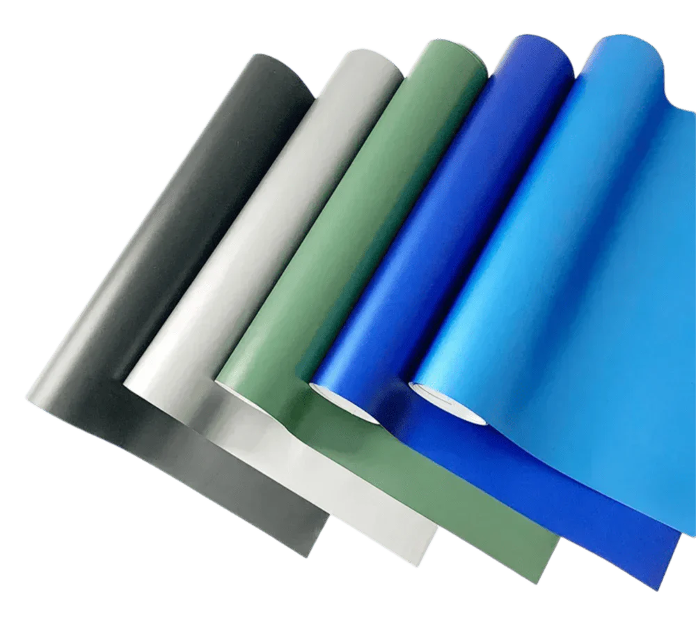 A collection of ChroMorpher Matte Vinyl rolls in shades of black, silver, green, and blue, arranged diagonally to highlight their smooth matte finish and versatility for modern customization projects.