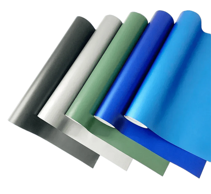 A collection of ChroMorpher Matte Vinyl rolls in shades of black, silver, green, and blue, arranged diagonally to highlight their smooth matte finish and versatility for modern customization projects.