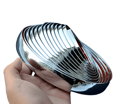 Hand holding a glossy chrome ChroMorpher Clip-On Trim Cover 2.0 roll showing the reflective mirror finish and flexible design