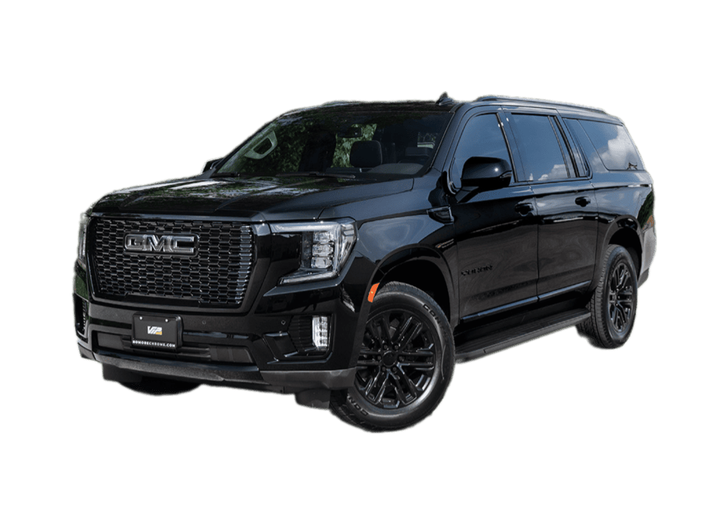 GMC SUV with blacked-out chrome accents, featuring a bold front grille and sleek design, highlighting its glossy black finish and black wheels.