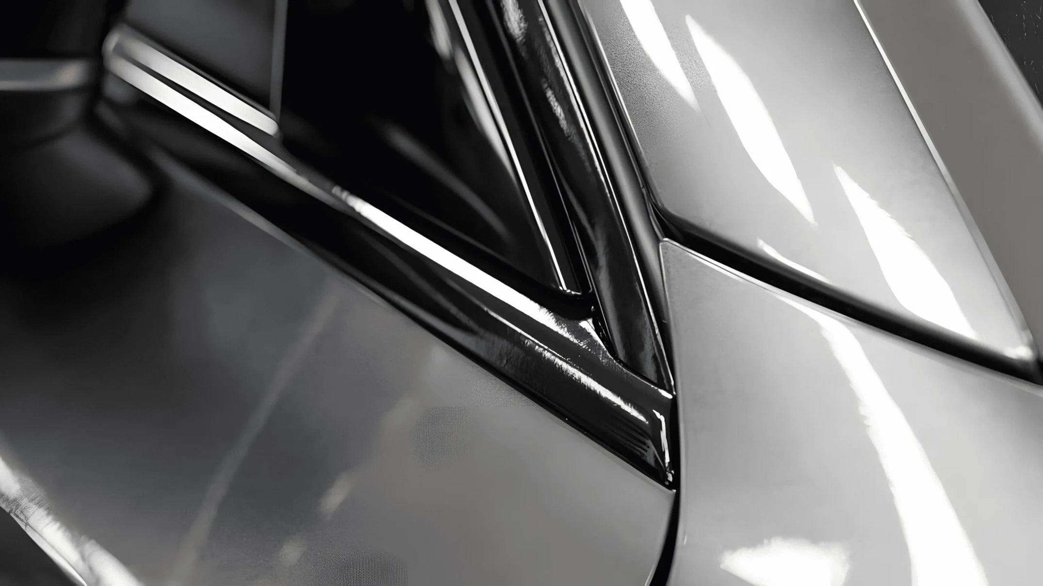 Close-up of pillar and side mirror trim wrapped with ChroMorpher Glossy Black Chrome Delete Tape for a seamless finish.