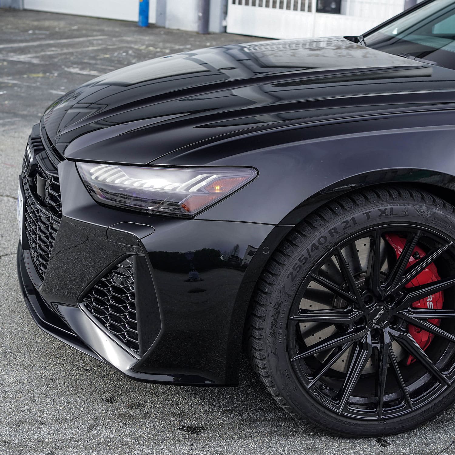 A high-gloss front of a car with chrome delete on the grille and body parts using ChroMorpher tape.