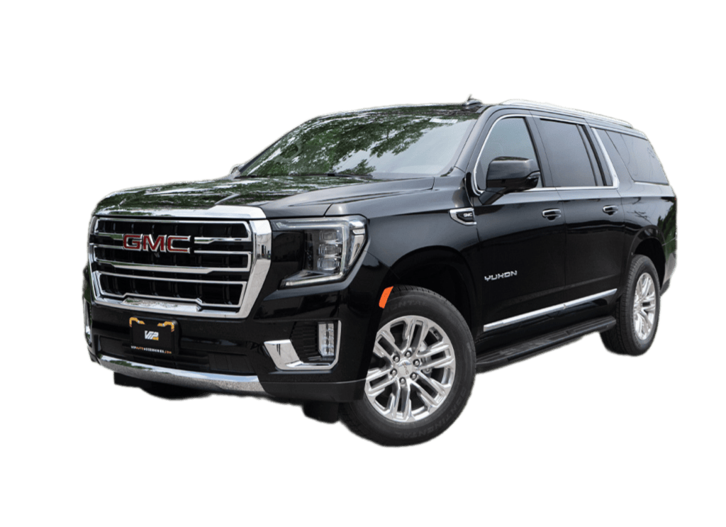 GMC Yukon SUV featuring chrome accents and a glossy black finish, with a bold front grille and silver wheels highlighting its premium design.