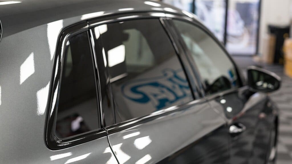 Close-up of a car's black chrome delete trim on the windows after the application of ChroMorpher Chrome Delete Tape.