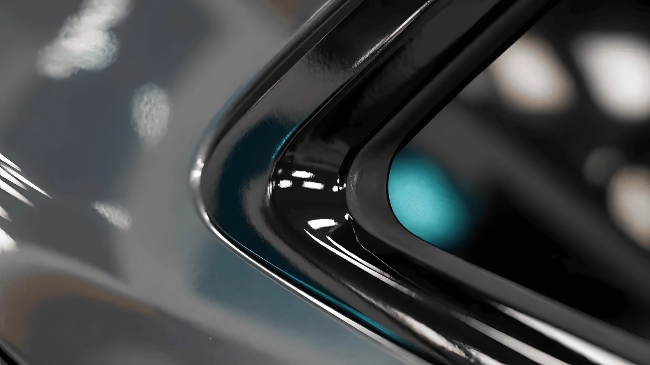 Close-up of glossy black chrome delete tape applied to a tight corner edge on car trim using ChroMorpher.