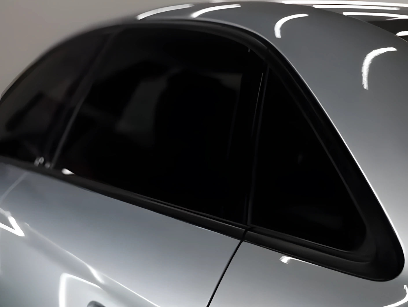 Car side window trim fully blacked out with ChroMorpher Glossy Chrome Delete Tape, showing clean finished result.